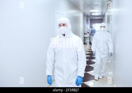 Doctors in protective uniforms working at hospital during coronavirus pandemic Stock Photo