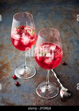 Cranberry rosemary spritzer drink on a dark background. Stock Photo