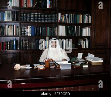 Saudi Arabia Businessman Sitting at Desk in Office Stock Photo