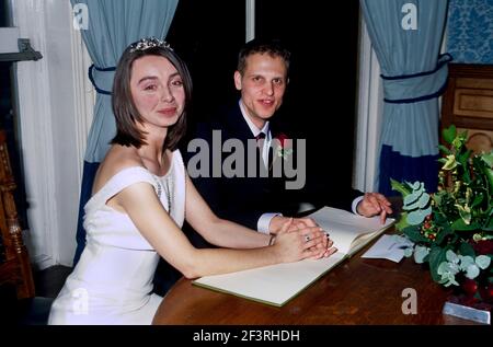 Bride & Groom Bride In Traditional White Dress Couple Signing Register Stock Photo