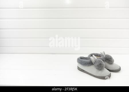 Beautiful fur slippers in the form on a white background, concept of comfort in the house Stock Photo