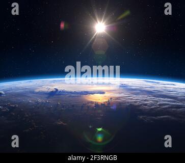 Planet Earth ans Sunrise. Earth View from Space in a star field showing the terrain and clouds. Elements of this image are furnished by NASA. Stock Photo