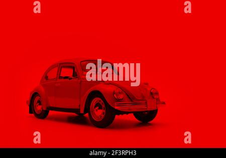 Izmir, Turkey - March 7, 2021: Front view of Red colored toy model car on a red background. Stock Photo