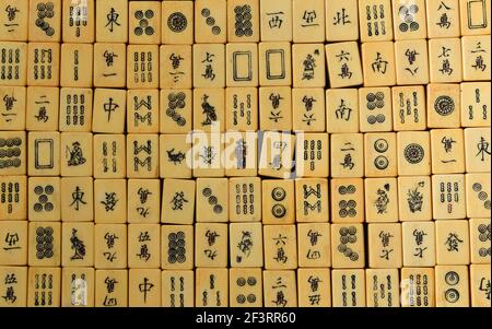 Vintage Bone and bamboo  Mahjong or mah-jongg playing tiles in box. Background. Stock Photo