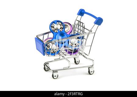 Fidget spinner in a shopping cart isolated on a white background. Concept to buying toy. Stock Photo
