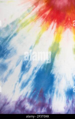 Pastel tie dye, a handmade pattern on a cotton t-shirt. Close-up, top view. DIY concept, handicrafts, original everyday clothes, fabric dyeing techniq Stock Photo
