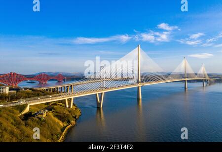 Aerial view from Rosyth showing three bridges spanning the Firth of Forth. The Queensferry Crossing, Forth Road Bridge and Forth Rail Bridge.
