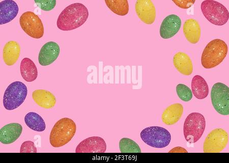 Trendy Easter layout made of flying colorful eggs on light pink background. Minimal easter concept. Creative Easter card with copy space for text. Stock Photo