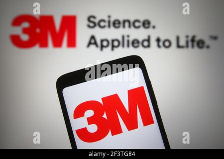 In this photo illustration the 3M company logo is seen on a smartphone and a pc screen. Stock Photo