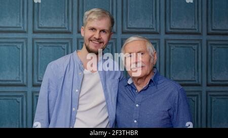 Happy bonding loving different male generations family of senior father and adult son or grandson Stock Photo