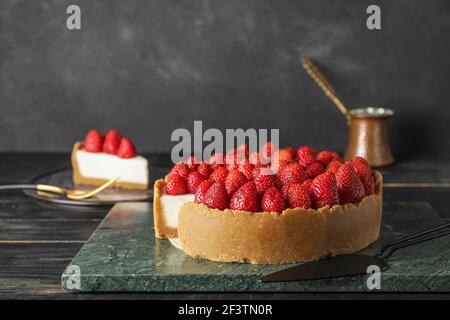 Tasty cheesecake with strawberry on table Stock Photo