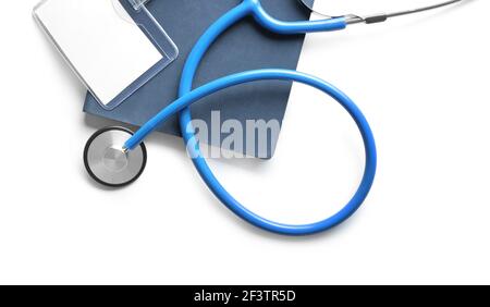 Stethoscope, notebook and blank badge on white background Stock Photo ...