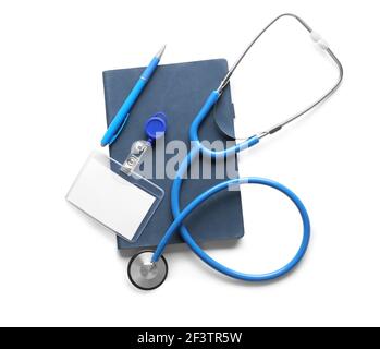 Stethoscope, notebook and blank badge on white background Stock Photo ...