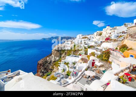 The steep cliffs of the caldera, the Aegean Sea and the whitewashed village of Oia with the Blue Dome Church in view on the island of Santorini Greece Stock Photo