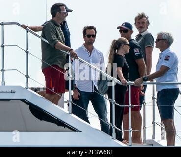 Auckland, New Zealand, 17 March, 2021 -  Owner of Ineos Team UK sailing team British billionaire Sir Jim Ratcliffe (2nd from right) prepares to view the final race of the 36th America's Cup on Auckland's Waitemata Harbour from his $100,000,000 super yacht Sherpa. Pictured with him are Ineos Team UK's founder and skipper Sir Ben Ainslie (white shirt)i with his wife Lady Ainslie (Georgie Thompson) and other guests. Following  Team New Zealand's (ETNZ) 7-3 victory over Italian challenger  Luna Rossa, Ineos Team UK are now believed to be the America's Cup Challenger of Record and will work with ET Stock Photo