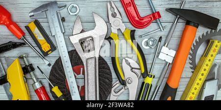 various renovation instruments and tools on grey background. screwdrivers, clamps, wrenches, keys top view Stock Photo