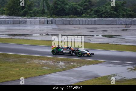 Nico Hulkenberg driving a Force India VJM07 at the entry to Spoon Curve at Suzuka Circuit during the rain affected 2014 Japanese Grand Prix. Stock Photo