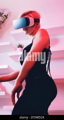Young woman using VR glasses. Virtual dating. High quality photo Stock Photo