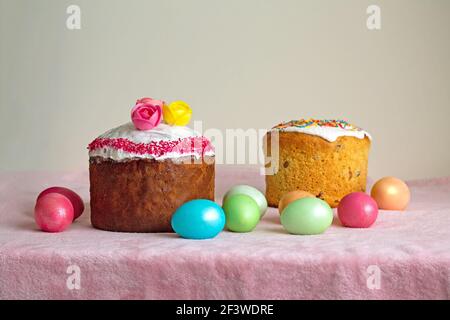Traditional Slavic Easter cake decorated with sprinkles. Colored chicken eggs. Spring celebration event. Stock Photo