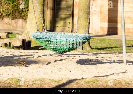 Empty comfortable swing seat at a playground in a residential area in Arnhem in the Netherlands Stock Photo