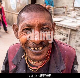 portrait of a poor man on street of india with selective focus on subject and added noise and grains. Stock Photo