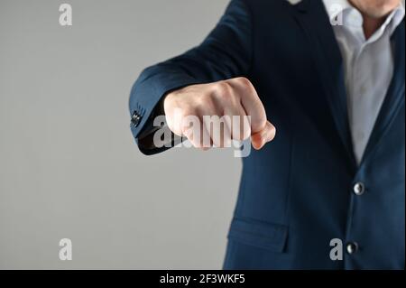 a man in a suit shows his fist. High quality photo Stock Photo