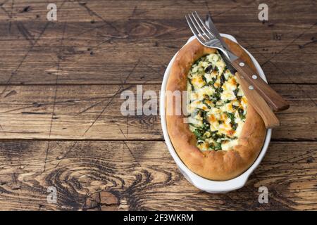 Open cheese pie with chard in Adjara style on the wooden table, top view. Delicious homemade food Stock Photo