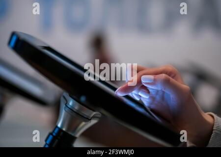 Futuristic, education, entertainment, learning, technology concept. Woman hand using touchscreen display of interactive floor standing black tablet ki Stock Photo