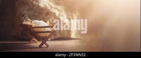 Wooden manger and star of Bethlehem in cave, nativity scene background ...