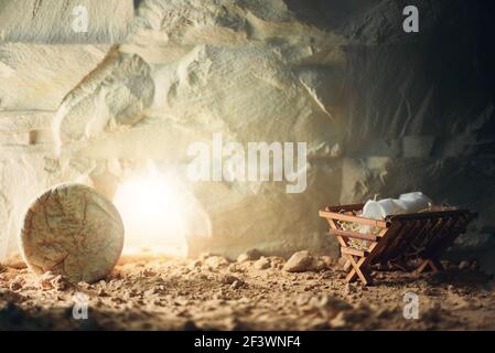 Christian Christmas and Easter concept. Chronology of Jesus life. Born to Die, Born to Rise. Wooden manger and empty tomb background. Jesus - reason Stock Photo