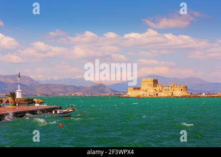 Lighthouse and Bourtzi fortress in the sea in Nafplio or Nafplion, Greece, Peloponnese Stock Photo