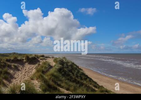 Overlooking Talacre beach from the grass covered sand dunes on a late summer's afternoon Stock Photo