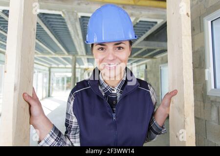 happy female builder indoors at building site Stock Photo