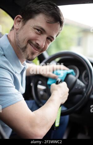young man cleaning the interior of his car Stock Photo