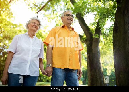 Happy and satisfied senior couple active at the park Stock Photo
