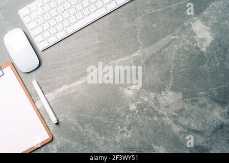 Business composition with white computer keyboard, mouse, clipboard, paper on marble background. Coffee break concept. Top view with copy space for Stock Photo