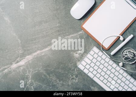 Business composition with white computer keyboard, mouse, clipboard, paper on marble background. Coffee break concept. Top view with copy space for Stock Photo