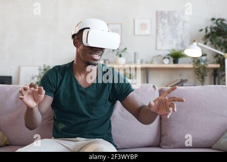 African young man playing video game during his leisure time at home Stock Photo
