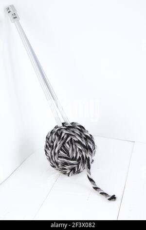 Ball of wool and knitting needles isolated on white background. Black and white. Stock Photo