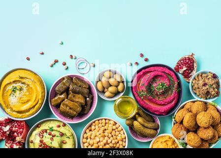 Mediterranean appetizer concept. Arabic traditional cuisine. Middle Eastern meze with pita, olives, hummus, stuffed dolma, falafel balls, pickles Stock Photo