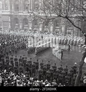 1950s, historical, a military parade at the Cenotaph, Whitehall, London, England, UK. The word Cenotaph is derived from the Greek word, meaning 'empty tomb' and symbolises the unprecedented losses suffered during the First World War. The memorial is dedicated to 'The Glorious Dead' and in 1946 was rededicated in 1946 to include those of the Second World War. Stock Photo