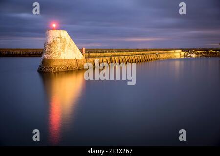 Saint-Vaast-la-Hougue (Normandy, north-western France): beacon at the entrance to the harbour. Red light in the morning Stock Photo