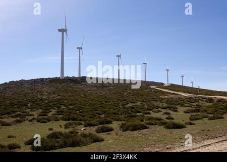 wind turbines producing electricity on a mountain divide in a strong wind Stock Photo