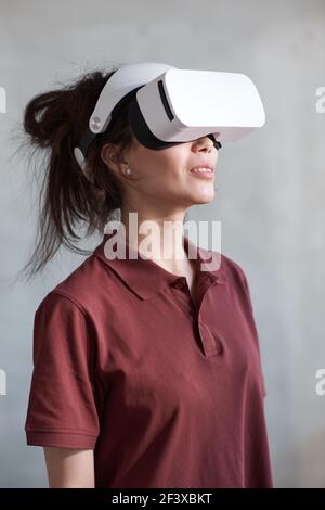 Young woman in 3D glasses watching virtual reality movie isolated on white background Stock Photo