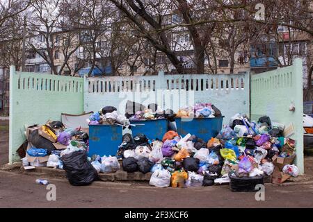 Full trash can. Trash can filled with trash. Trash can packed to overflowing with rubbish. The bin is filled with rubbish. Stock Photo