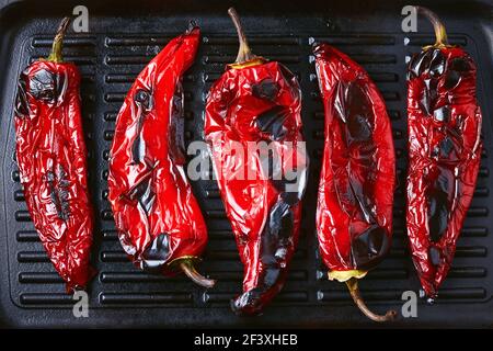 Close-Up Of Roasted Red Peppers On Grilling Pan. Stock Photo