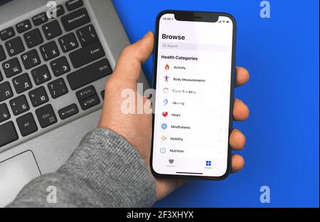 Kharkov, Ukraine - March 9, 2021: man use Apple Health app on Apple iPhone 12 mini, functional of application Stock Photo