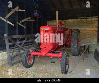 Farmall McCormick  International Tractor in farm building. Stock Photo