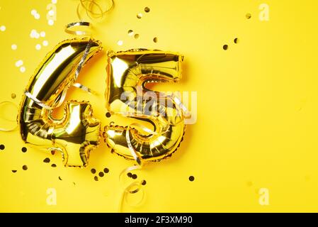 Gold foil balloon number, digit forty-five. Birthday greeting card, inscription 45. Anniversary celebration event. Banner. Golden numeral, yellow Stock Photo