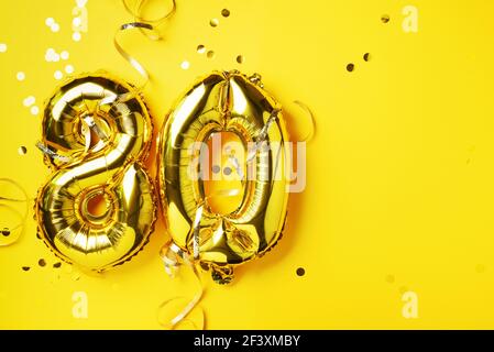 Gold foil balloon number, digit eighty. Birthday greeting card, inscription 80. Anniversary celebration event. Banner. Golden numeral, yellow Stock Photo
